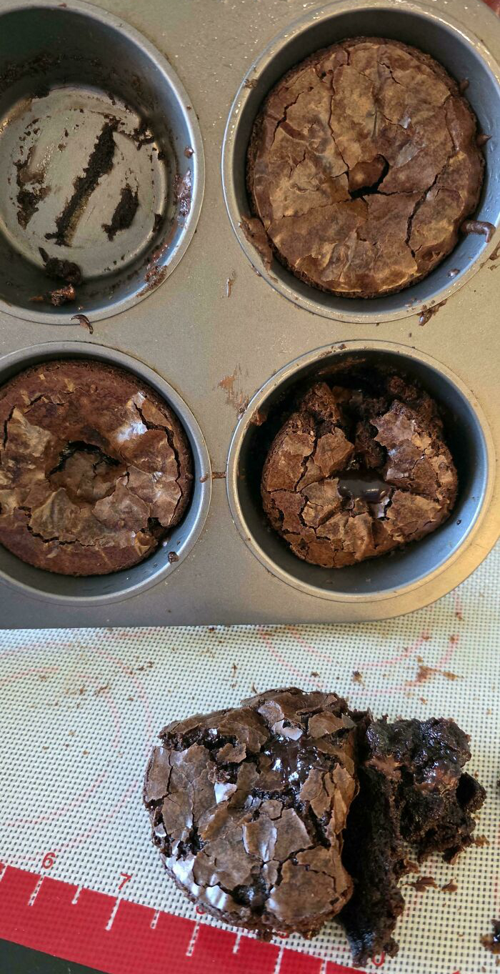C*****d and broken brownies in a muffin tray with one piece crumbled on a baking mat showing dessert ruined attempts.