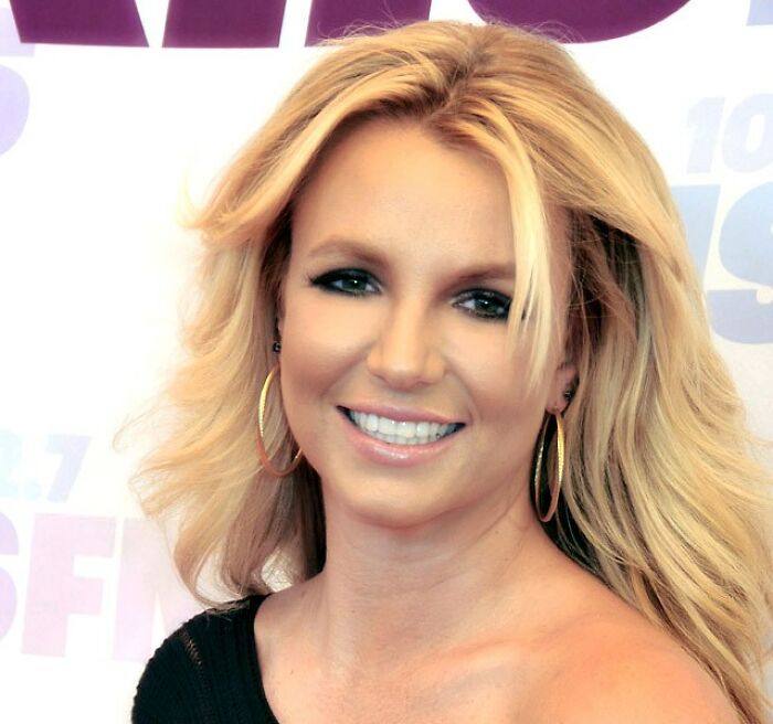 Blonde woman with hoop earrings smiling at an event about the fastest times couples said I do and I'm done.