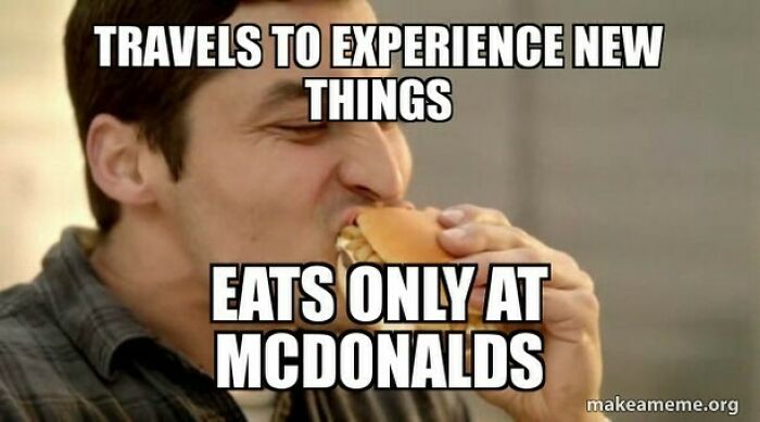 Man eating a burger with a travel meme about experiencing new things and eating only at McDonalds for travel memes.