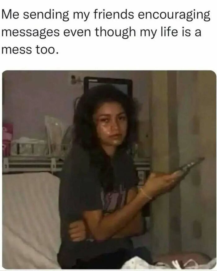 Young woman sitting alone, looking tired and emotional while holding a phone, relatable meme about introvert life.