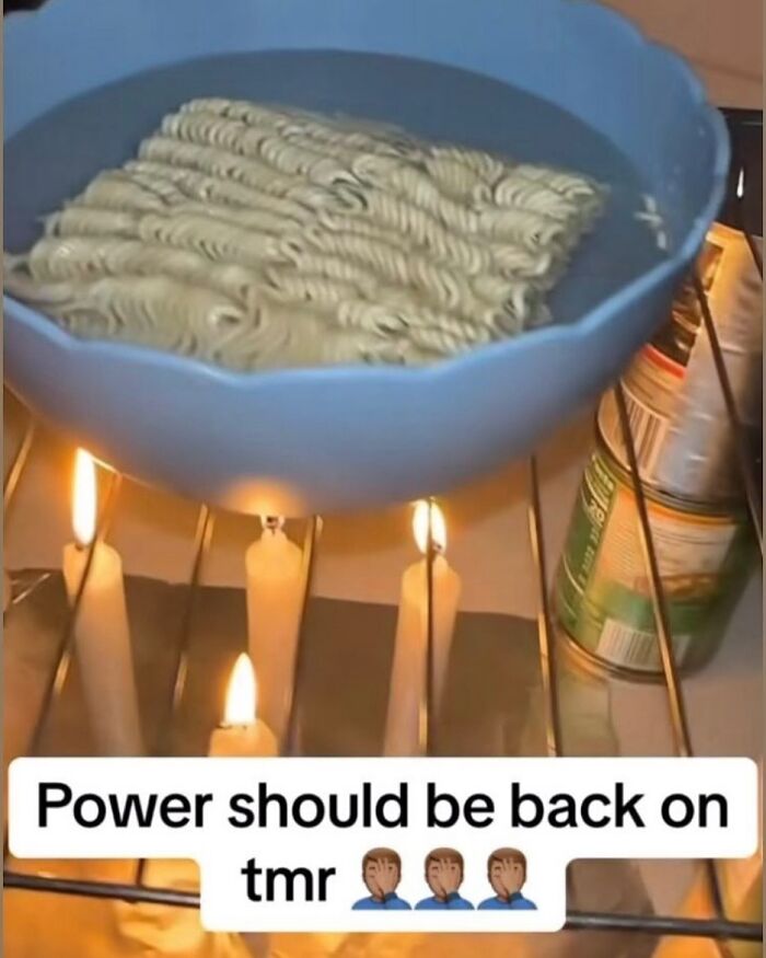 Instant noodles boiling in a bowl heated by candles, a funny screenshot capturing creative cooking without power.