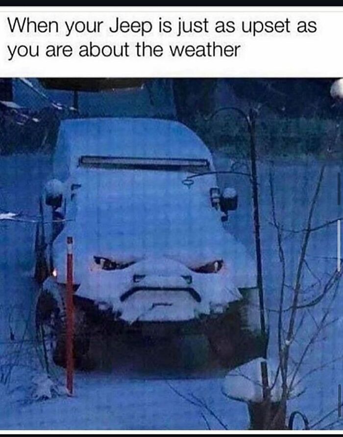 Jeep covered in snow with an angry face created by the snow, capturing a random meme filled with unexpected humor.