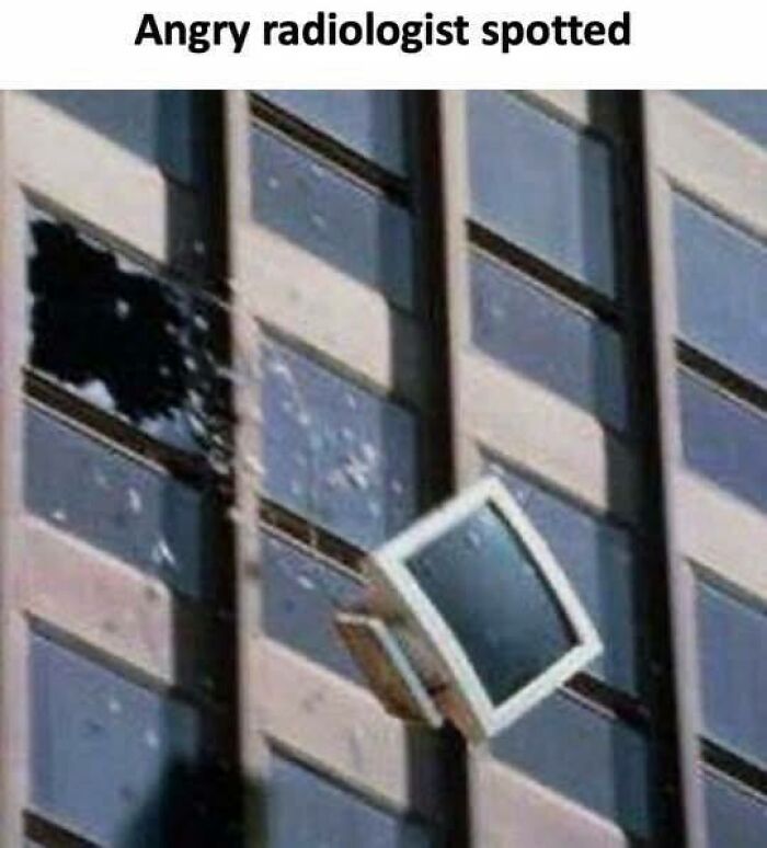 Old computer monitor breaking through a window on a building, illustrating humor and memes about healthcare costs.