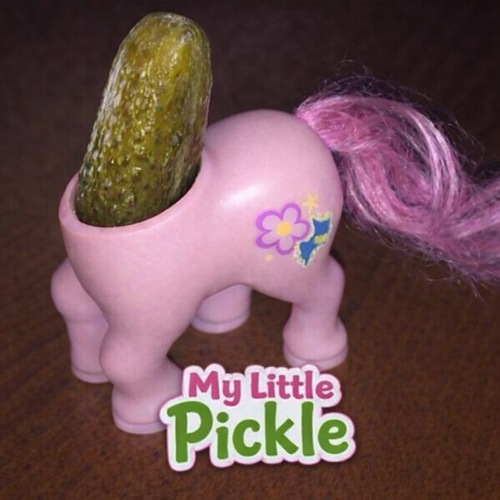 Toy horse figurine with pink mane holding a pickle, representing random and bizarre memes that confuse the viewer.