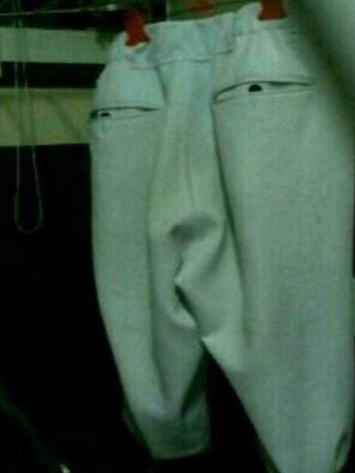 Pair of pants hanging with pockets resembling a face, a bizarre meme that might leave you with more questions than answers.