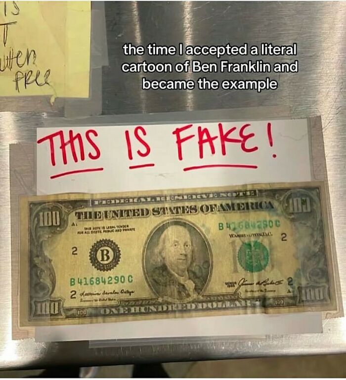 Fake one hundred dollar bill taped to a surface with a sign saying this is fake in a random meme with funny text.