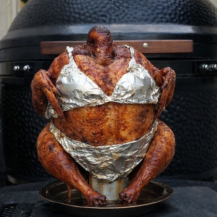 Roasted chicken wearing a bikini made of foil, creating a bizarre and random meme visual with humorous effect.