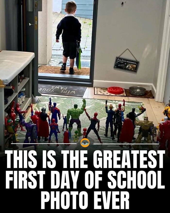 Young child walking out the door greeted by superhero toys lined up, capturing a lighthearted fact and pic moment.