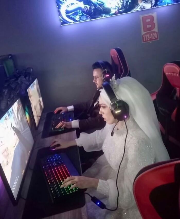 Bride and groom wearing gaming headsets, playing video games on computers, showcasing random and bizarre memes humor concept.