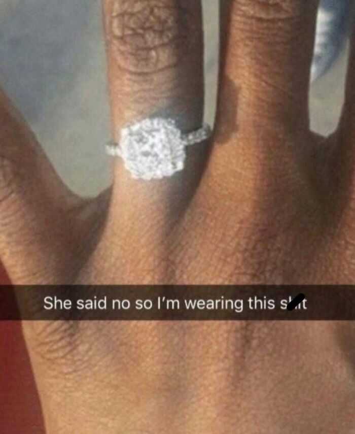 Close-up of a hand wearing a large sparkling ring with a caption reflecting a bizarre meme for more questions than answers.