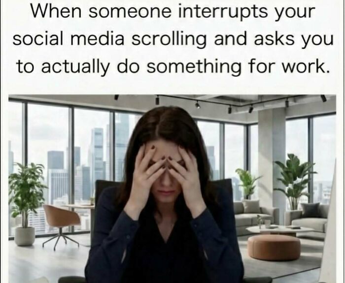 Woman stressed at office desk when interrupted from social media scrolling to do work, illustrating funny memes distraction.