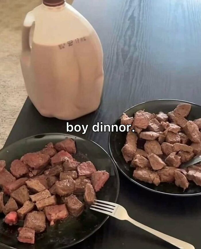 Two plates of cooked meat and a gallon of chocolate milk on a table with bizarre memes text boy dinnor.