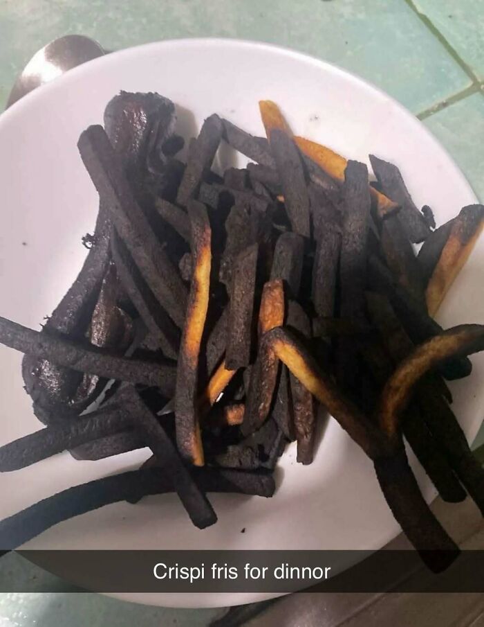 Burnt fries on a white plate, showcasing a random and bizarre meme that leaves more questions than answers.