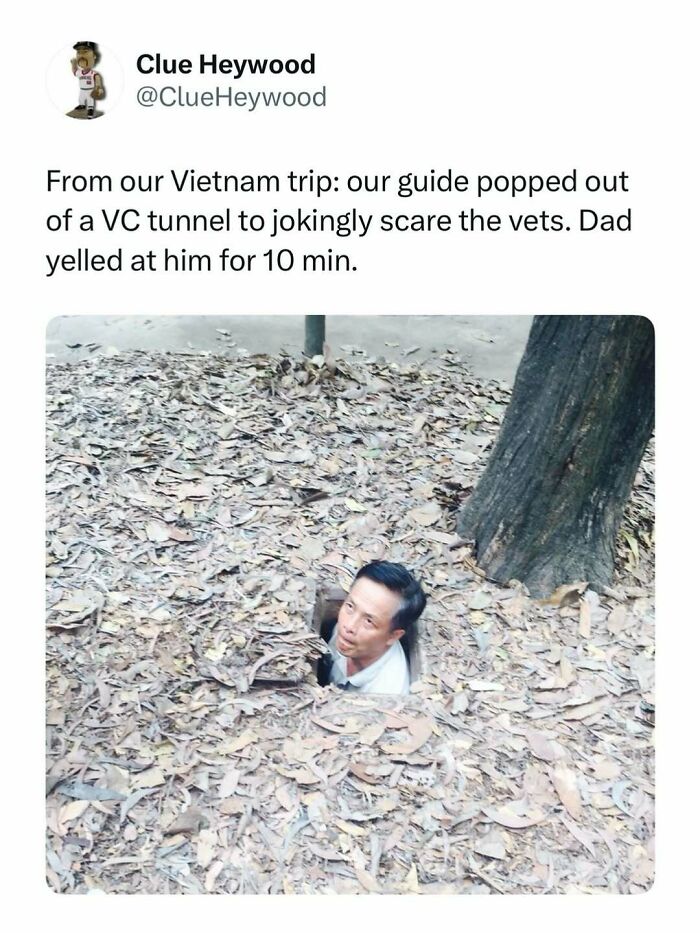 Man emerging from a tunnel covered in leaves during a Vietnam trip, shared in entertaining posts and memes to fight boredom.