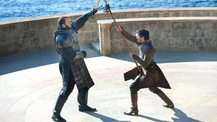 Two men in medieval armor sparring with weapons outdoors, illustrating Peter Claffey's height compared to Ser Duncan the Tall.