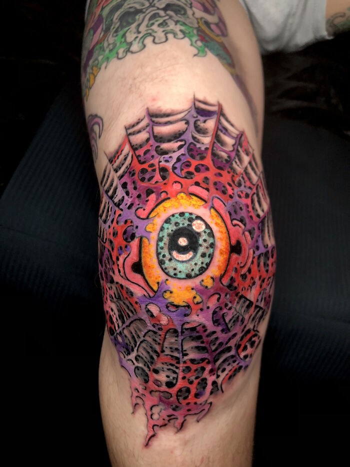 Colorful tattoo of an intricate eye design on a leg, showcasing cool tattoos that look almost unreal.