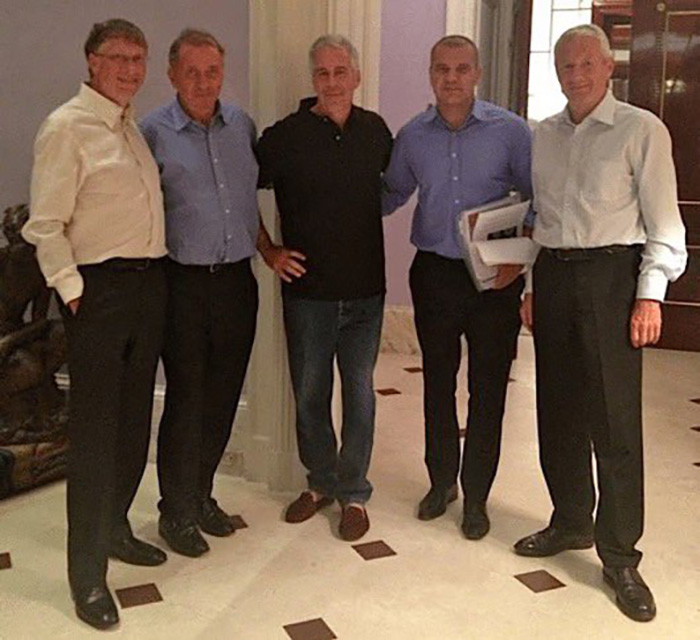 Bill Gates and Jeffrey Epstein standing with three other men inside a room with tiled floor and casual clothing.