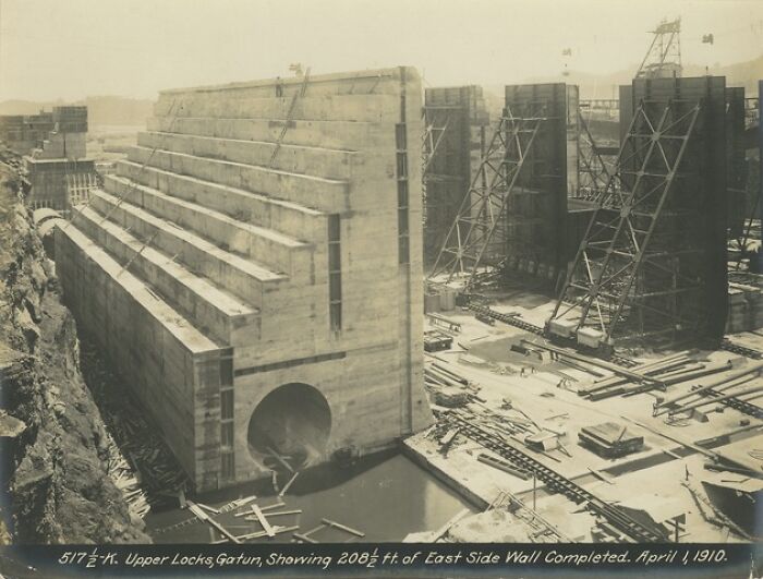 Construction site of large concrete lock structures, showcasing early 20th-century engineering for shipping containers transport.