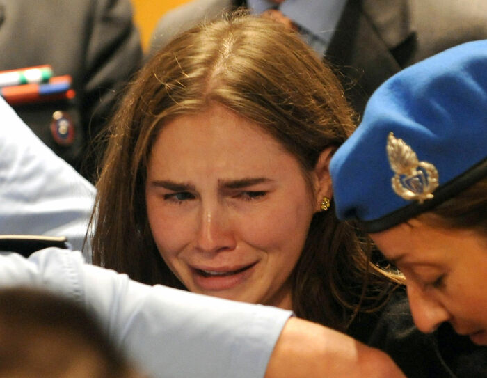 Amanda Knox emotional in court as she responds, highlighting tensions in feud and cancel culture debate.
