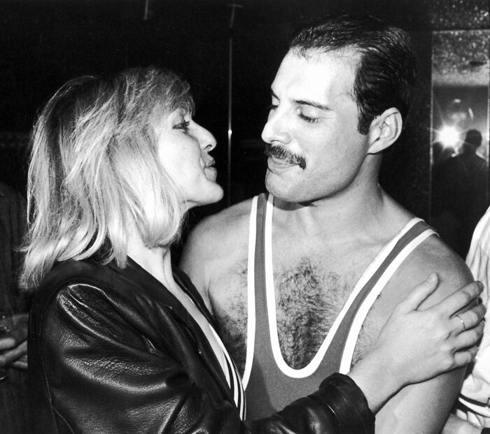 Freddie Mercury with a woman in a candid moment, highlighting Freddie Mercury's secret daughter recently revealed and her passing.