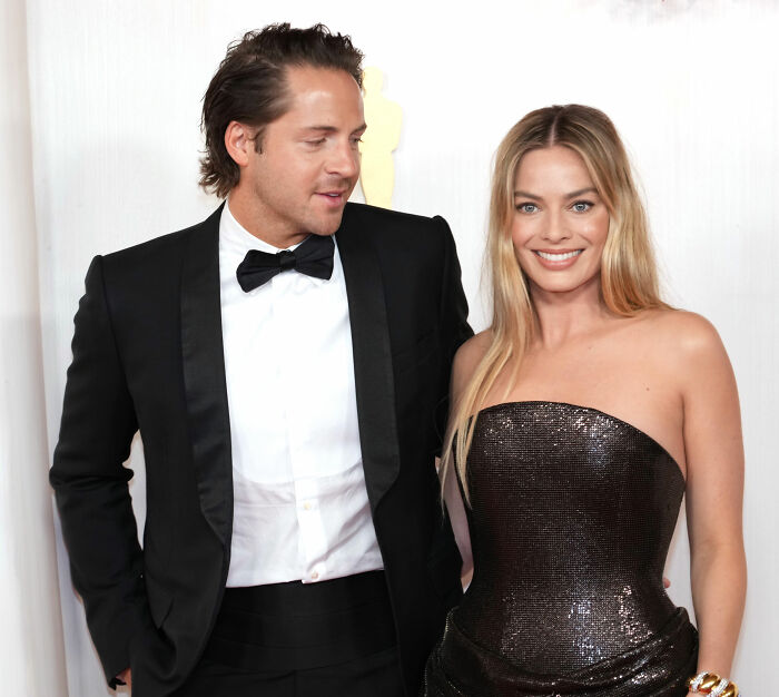 Margot Robbie and Jacob Elordi posing together at an event, fueling rumors about their on-set relationship.