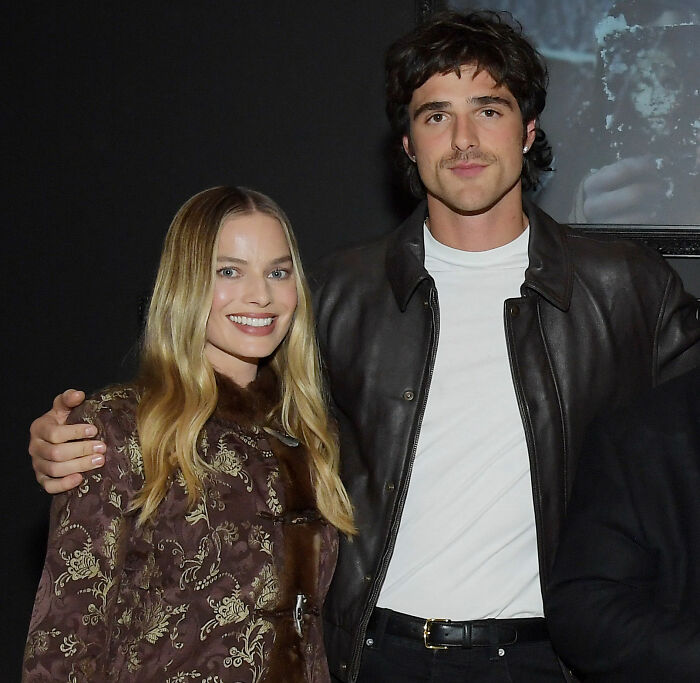 Margot Robbie and Jacob Elordi posing together on set, fueling rumors about their Wuthering Heights relationship.