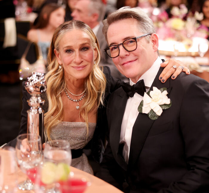 Chris Noth and Sarah Jessica Parker smiling together at an event, linked to fan backlash and off the cuff remarks.
