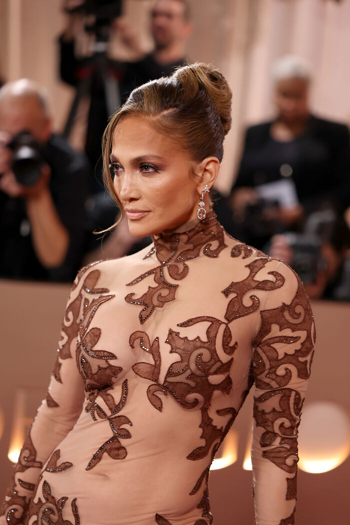 Jennifer Lopez at Golden Globes wearing an intricate sheer gown, sparking ageist backlash over her bold fashion choice. Jennifer Lopez at Golden Globes wearing an intricate sheer gown, sparking ageist backlash over her bold fashion choice.