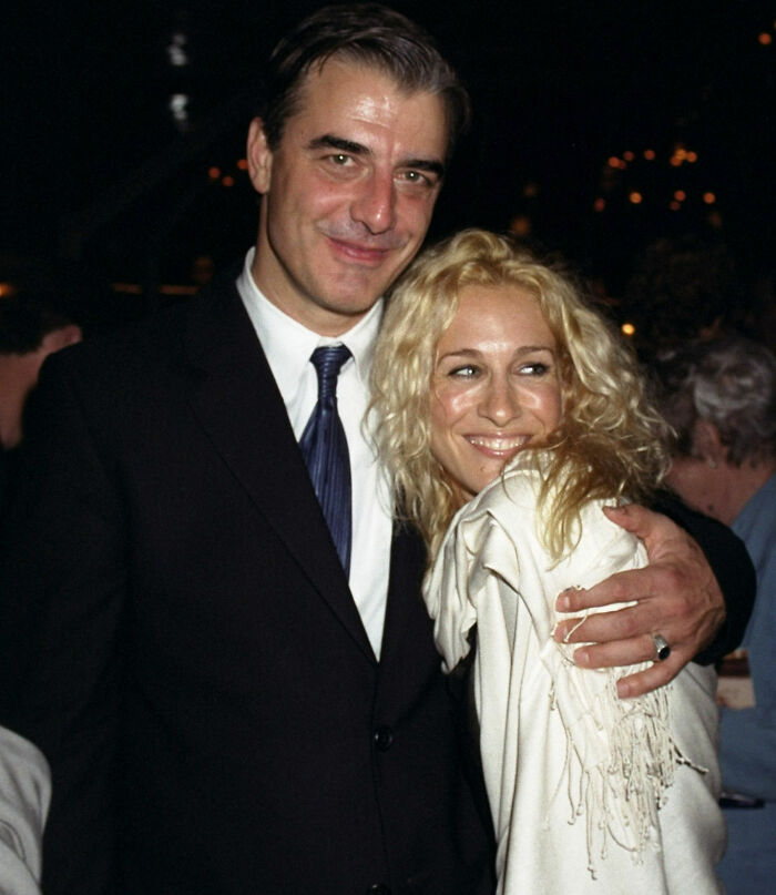 Chris Noth and Sarah Jessica Parker smiling together at an event with Chris Noth breaking silence after fan backlash.