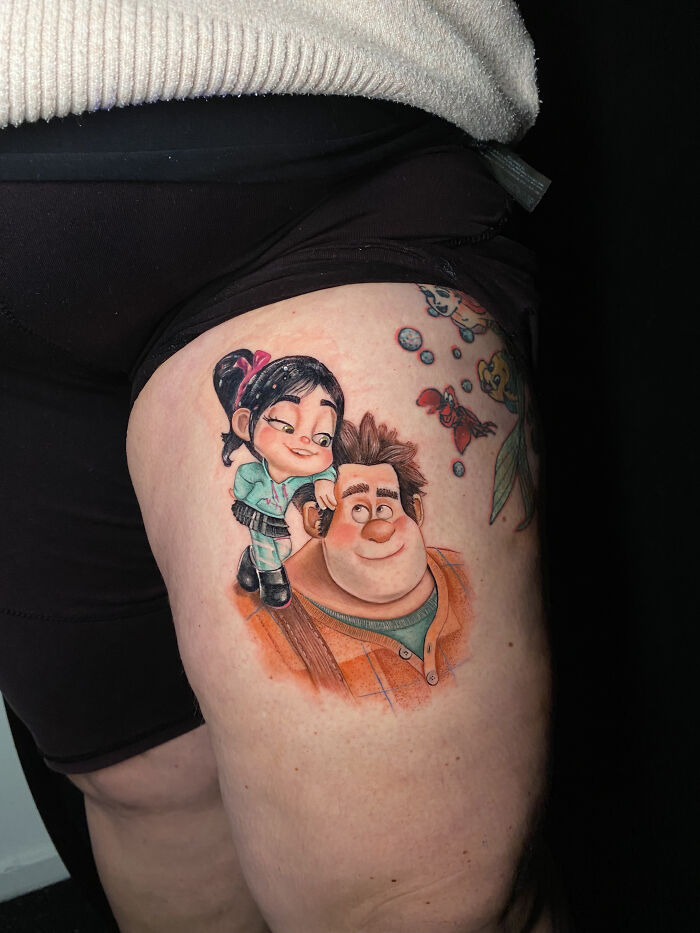 Colorful tattoo of animated characters on thigh, a cool tattoo design that looks so realistic and eye-catching on skin.