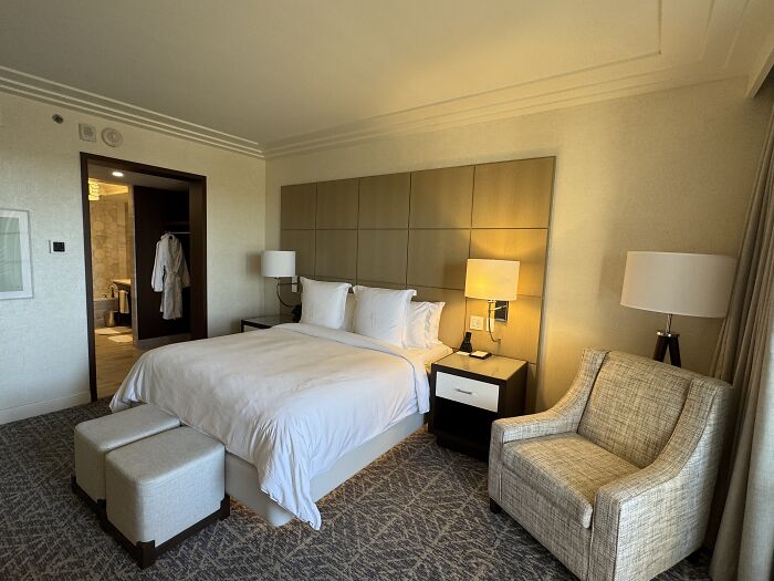 Quiet and beautiful hotel room in Central Florida featuring a cozy bed, armchair, and soft lighting creating a peaceful atmosphere