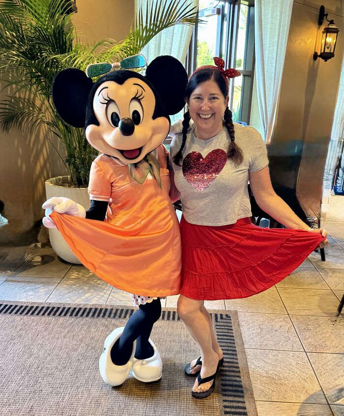 Woman smiling and posing with Minnie Mouse character in Central Florida, highlighting beauty and real emotion.