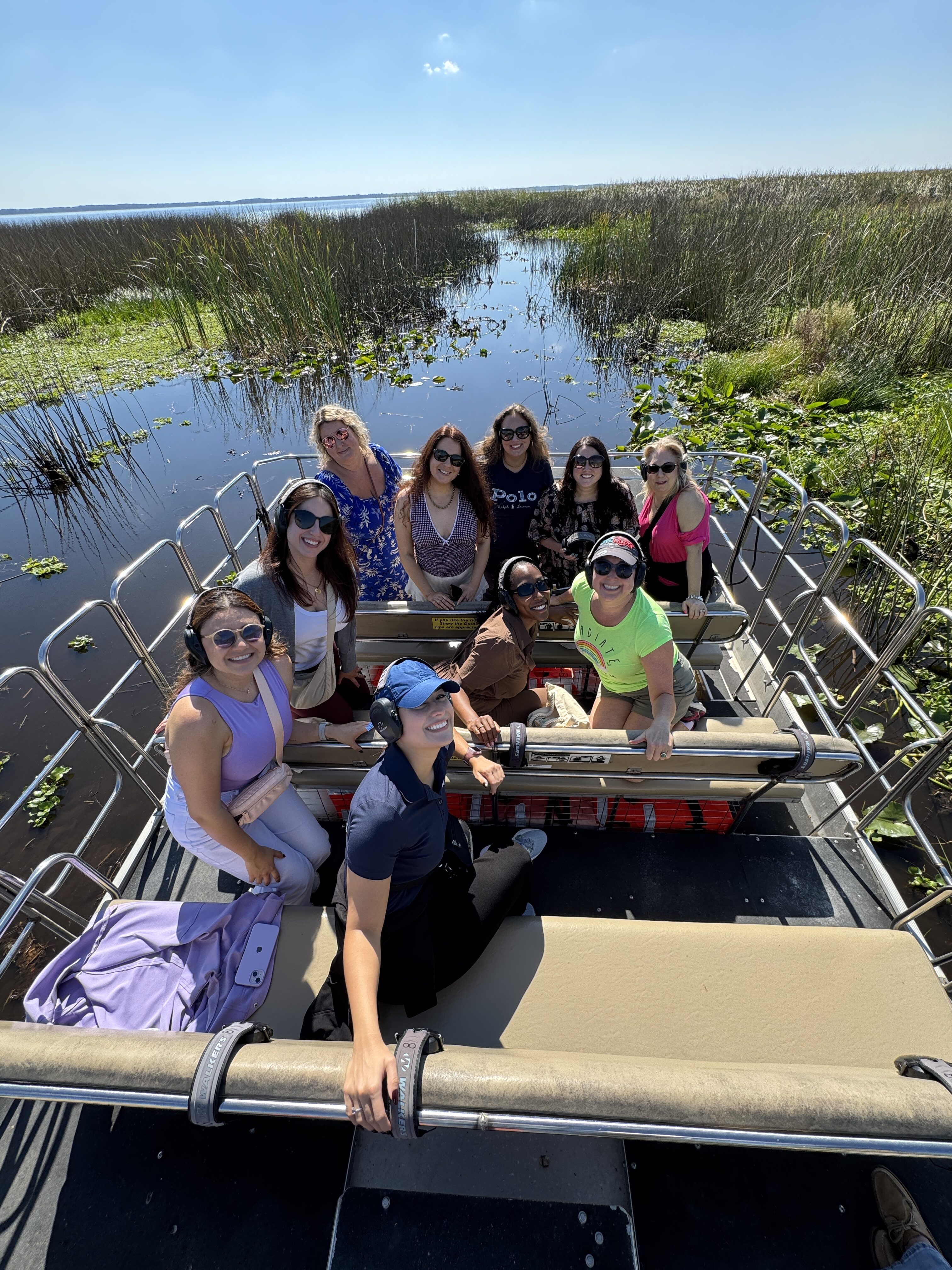 Group of people enjoying a quiet airboat tour in the serene and beautiful wetlands of Central Florida.