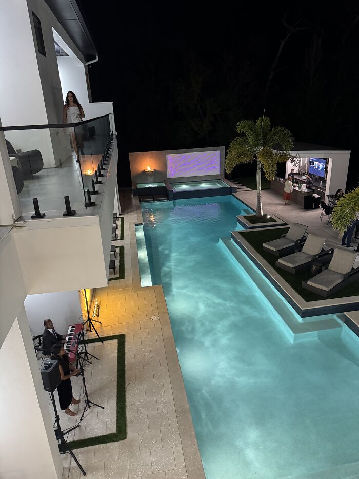 Modern Central Florida pool area at night with live music, outdoor seating, and serene beauty under starry sky.