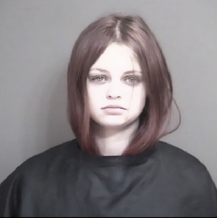 Young woman with shoulder-length hair in a mugshot photo related to Marine veteran&rsquo;s heartbreaking final text case.