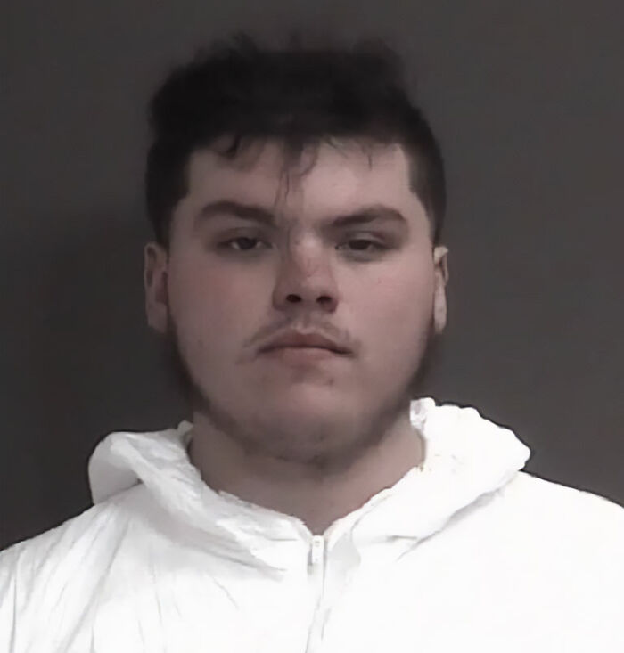Mugshot of a young man wearing a white hoodie, related to a Marine veteran's heartbreaking final text after a tragic Facebook Marketplace meetup.