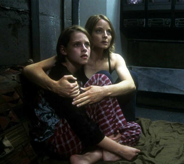 Two young girls sitting closely together in pajamas, illustrating Jodie Foster's experience with Hollywood predators as a child.