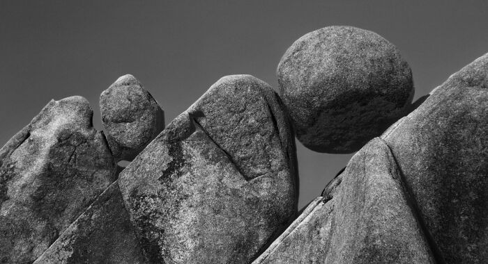 Balancing granite boulders against a clear sky in a stunning natural animal photo from a non professional category.