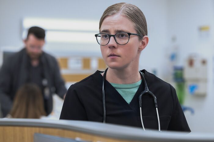 Female medical professional wearing glasses and stethoscope, focusing intently in a hospital setting, depicting medical drama disorder. Female medical professional wearing glasses and stethoscope, focusing intently in a hospital setting, depicting medical drama disorder.