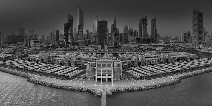 Aerial view of a modern city skyline and waterfront showcasing breathtaking architecture and urban design.