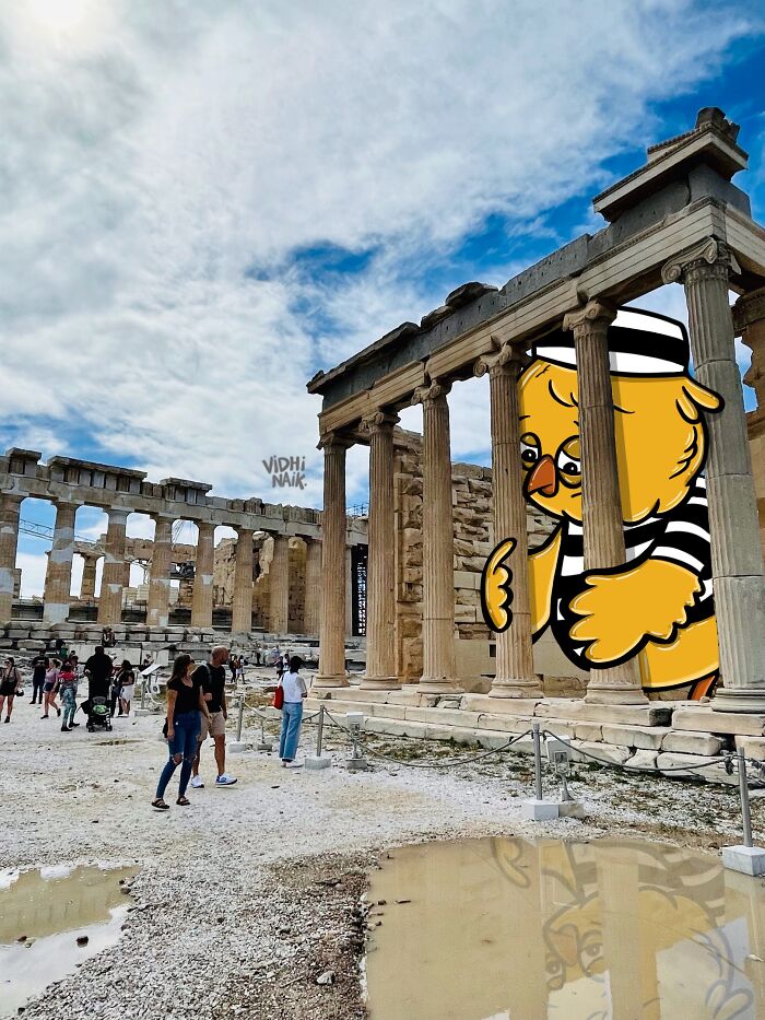 Ancient ruins with cartoon art of a giant bird in striped clothes integrated into the scene by an artist.
