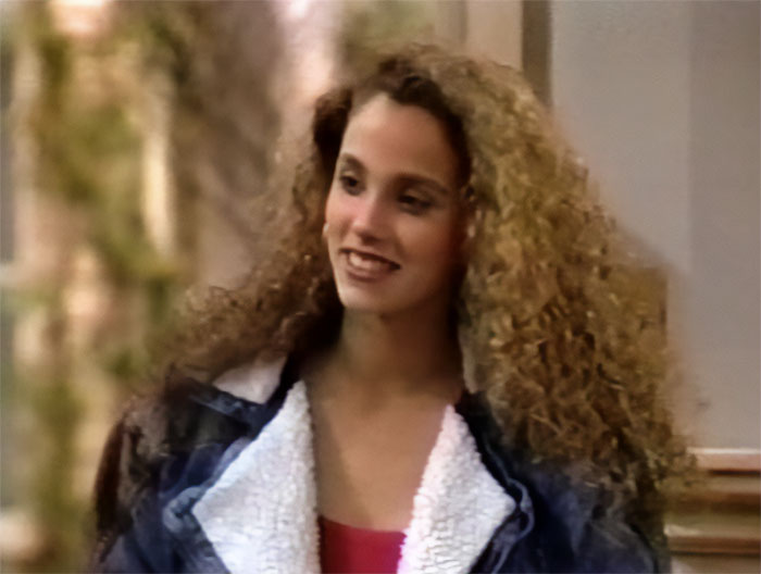 Young woman with long curly hair wearing a jacket, representing celebrity downfalls that evoke sympathy.