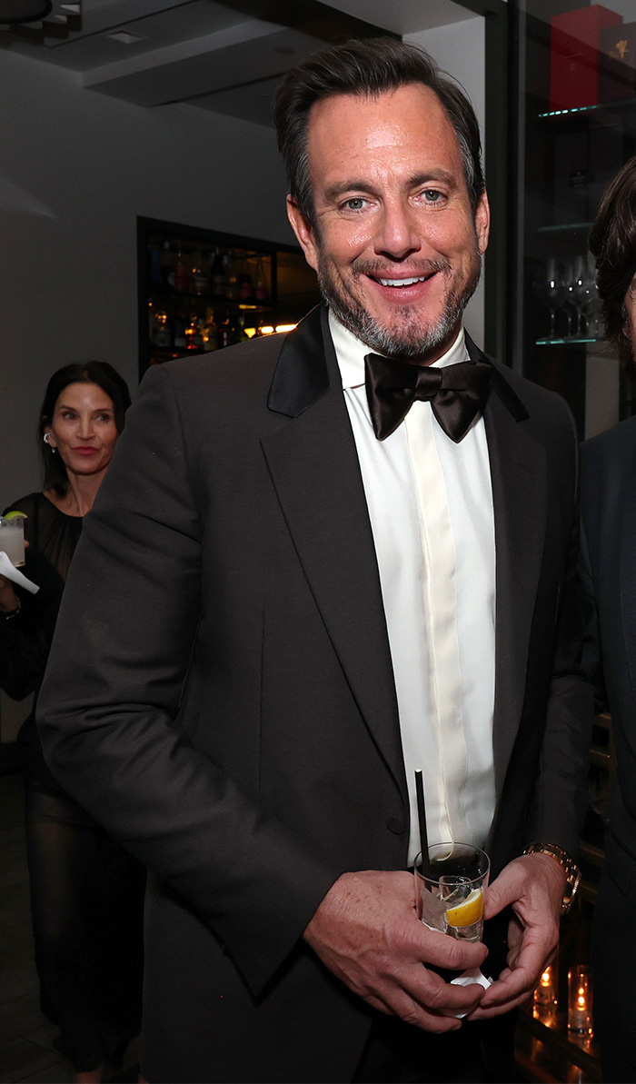 Man in a black tuxedo with bow tie smiling and holding a cocktail at the 2026 Golden Globes after-parties event.