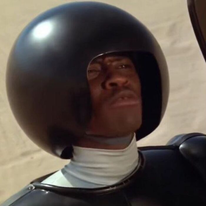 Man wearing large round helmet and black armor, with a serious expression, reflecting internet buzz about cream cheese review. Man wearing large round helmet and black armor, with a serious expression, reflecting internet buzz about cream cheese review.