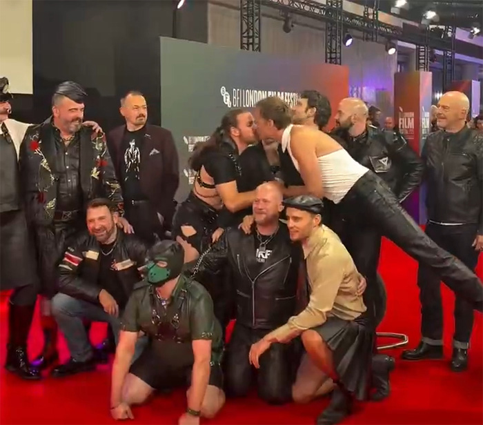 Group of men in leather and edgy outfits posing on a red carpet at an event featuring Alexander Skarsg&aring;rd orientation discussion.