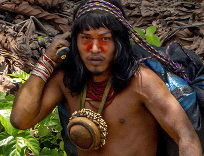 Uncontacted Amazonian tribe member with traditional face paint and accessories in the dense jungle environment. Uncontacted Amazonian tribe member with traditional face paint and accessories in the dense jungle environment.