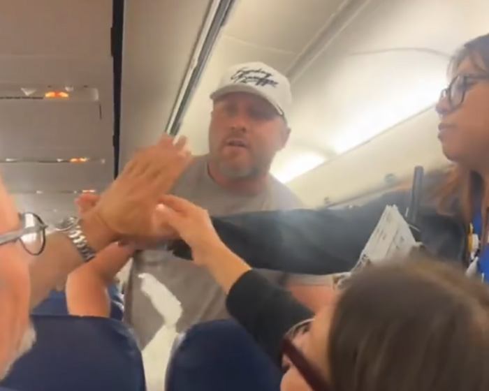 Bodybuilder removed from flight after furious confrontation with elderly passenger inside airplane cabin.