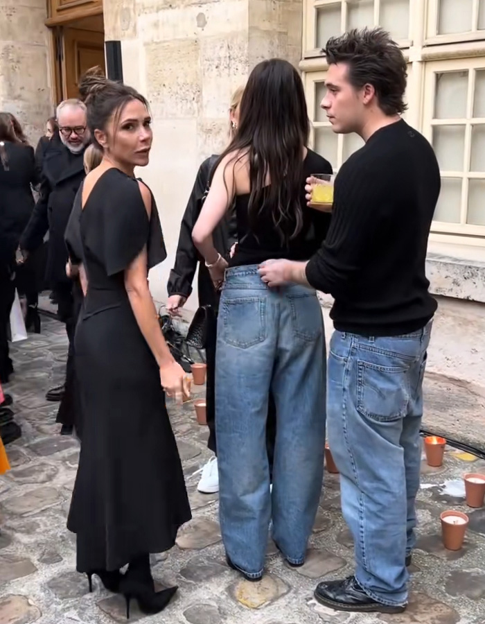 Victoria Beckham in black dress with Nicola Peltz and others in casual outfits during a tense public moment amid feud.