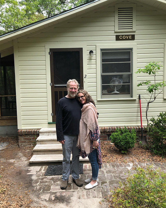 Timothy Busfield and a woman standing outside a small house, showcasing the home before federal agents&rsquo; forced entry.