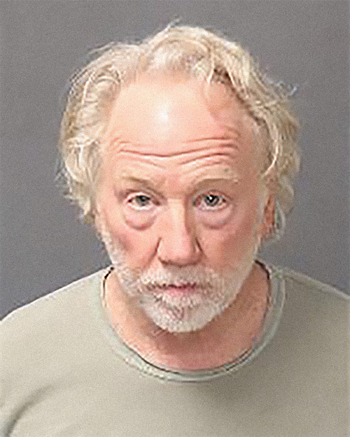 Mugshot of a man with white hair and beard, related to armed federal agents and accusations incident.
